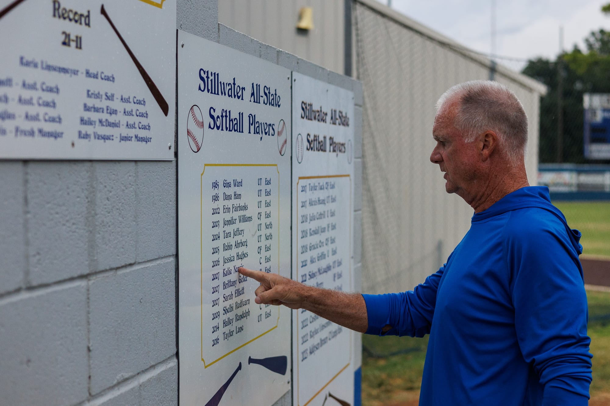 Chris Norris points to the Stillwater High School softball All-State players recognition board.
