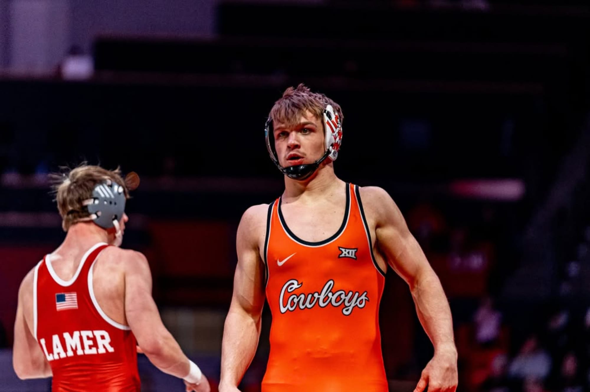 Casey Swiderski in orange Oklahoma State singlet during match against Nebraska
