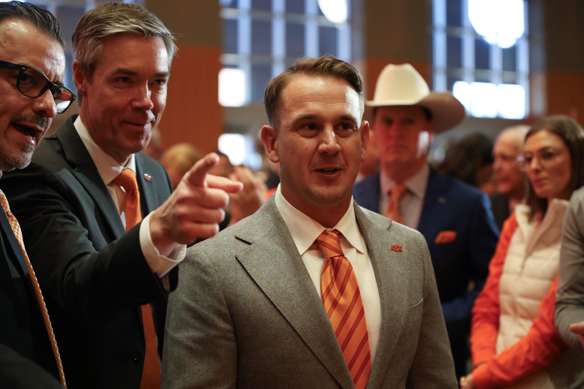 Eric Morris greets supporters at his Oklahoma State introductory press conference Dec. 8 in Stillwater alongside athletic director Chad Weiberg
