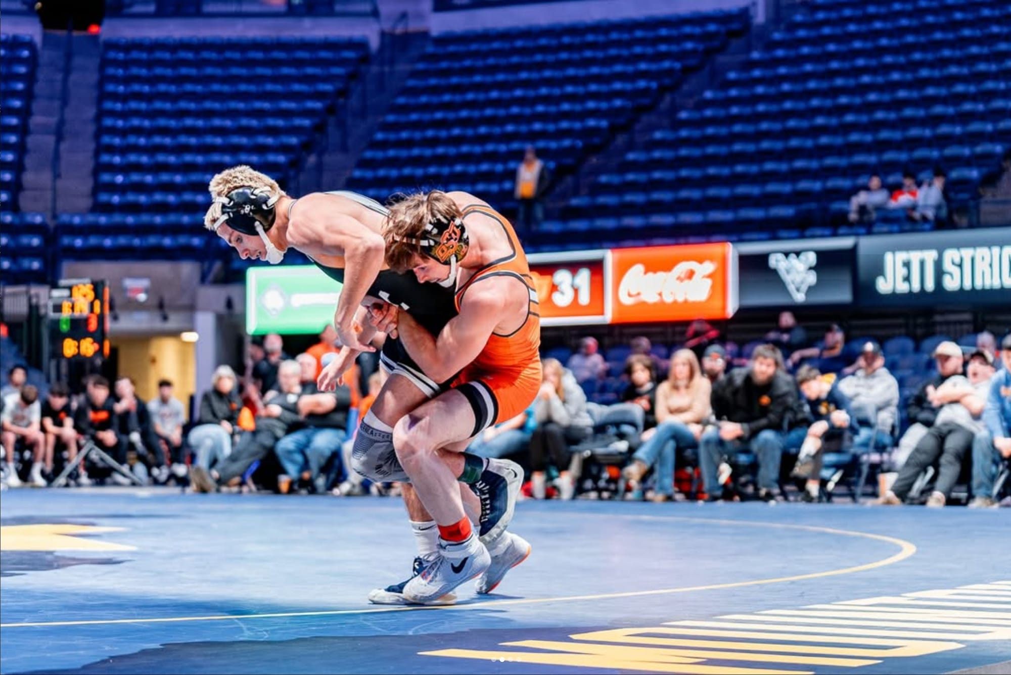 Oklahoma State's Troy Spratley executes a takedown on West Virginia's Jett Strickenberger during their 125-pound match at Gallagher-Iba Arena. 