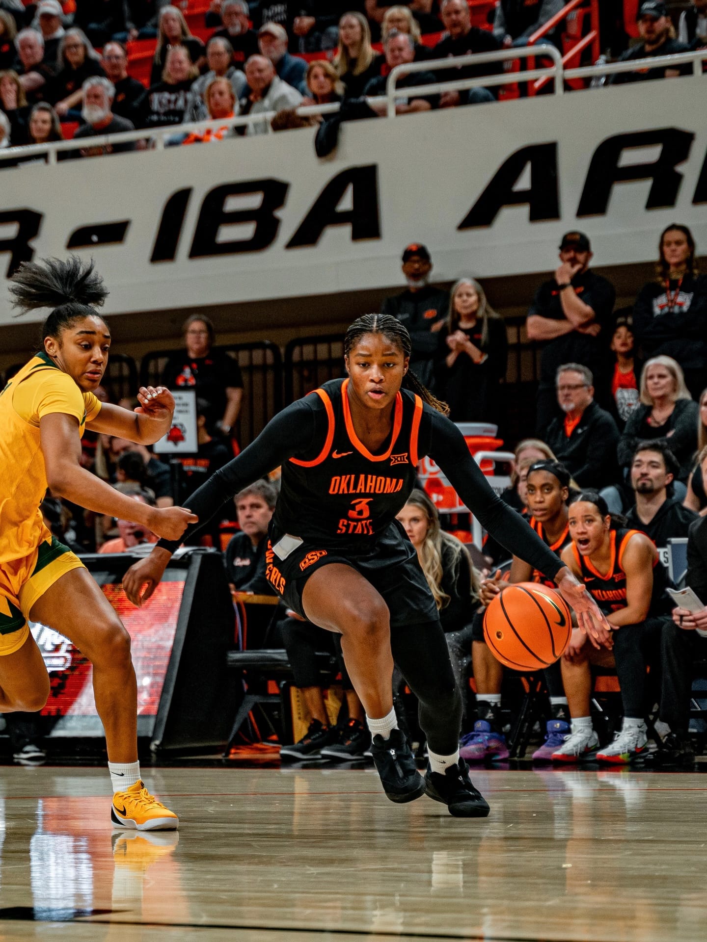 Oklahoma State guard Micah Gray dribbles the basketball against a Baylor defender during the Cowgirls' 77-68 loss on New Year's Eve at Gallagher-Iba Arena in Stillwater, Oklahoma.