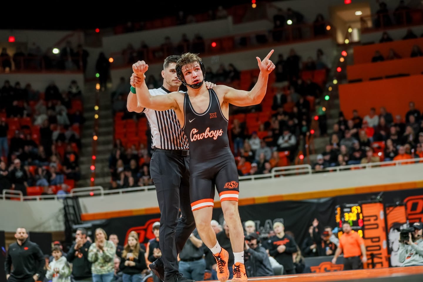 OSU's Casey Swiderski celebrates victory with referee raising his hand after defeating Northern Iowa's Caleb Rathjen 9-2 at Gallagher-Iba Arena Jan. 30, 2026