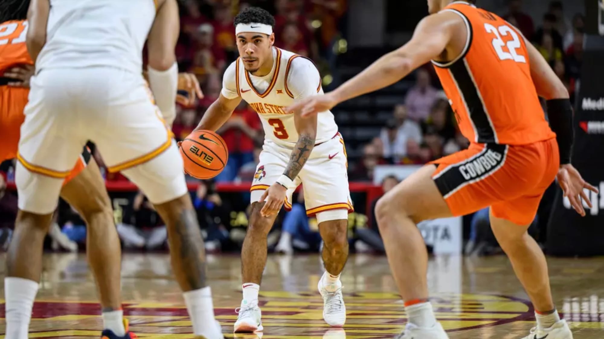 Iowa State guard Tamin Lipsey dribbles while surveying the court as Oklahoma State's Parsa Fallah defends during the Cyclones' 83-71 win at Hilton Coliseum.