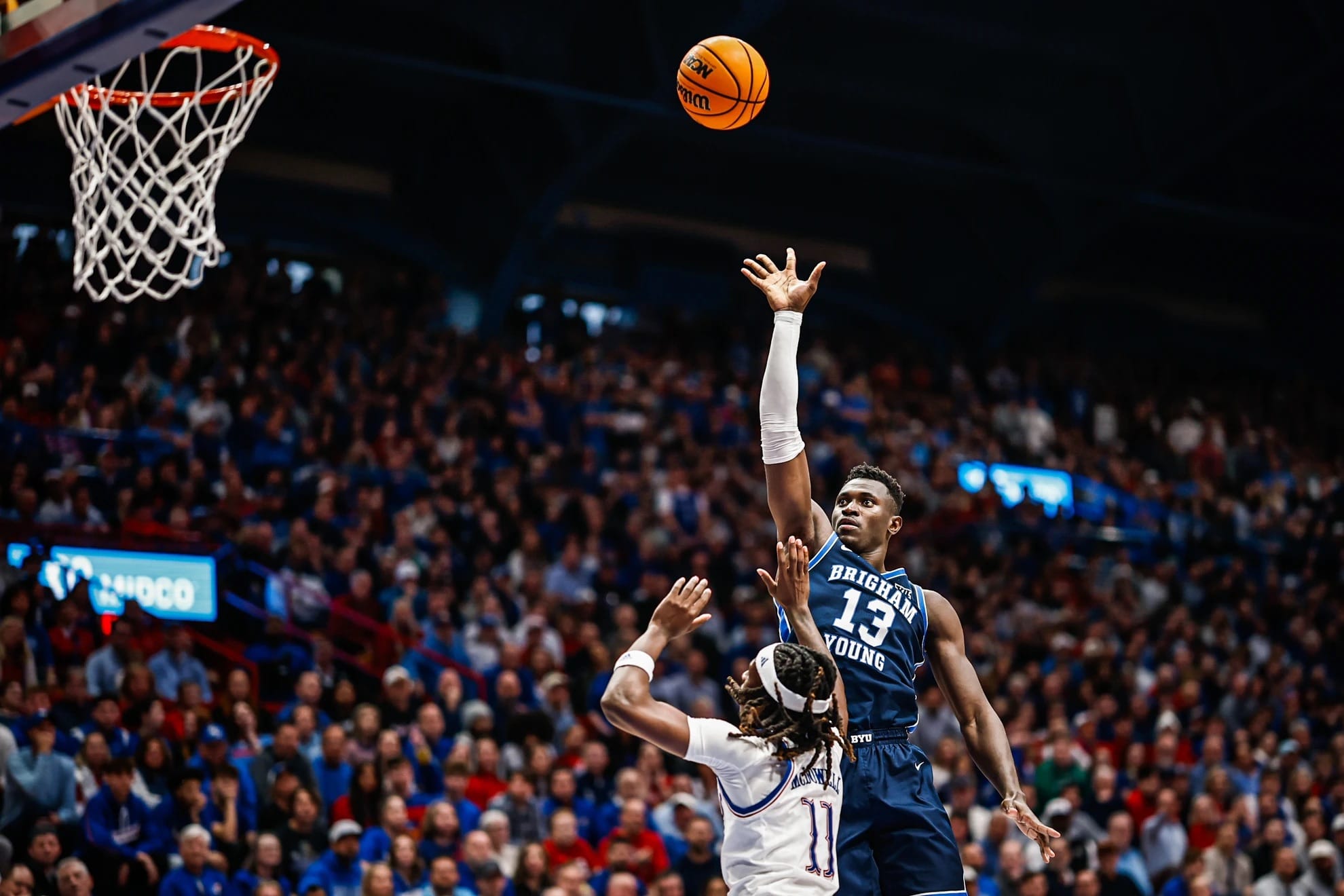 BYU freshman forward AJ Dubansya elevates for a shot over a Kansas defender during Big 12 action at Allen Fieldhouse. Dubansya leads the Cougars in scoring at 19.4 points per game.