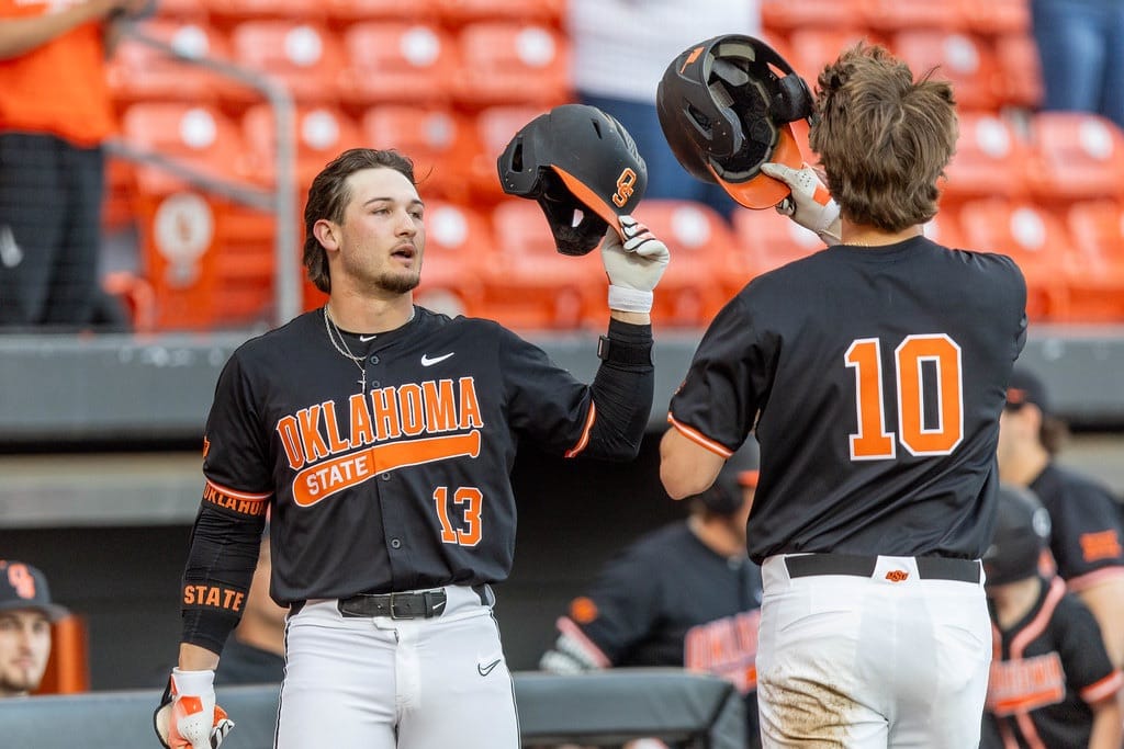 Oklahoma State's Kollin Ritchie (13) celebrates with teammate after scoring run vs North Dakota State at O'Brate Stadium, March 18, 2025.