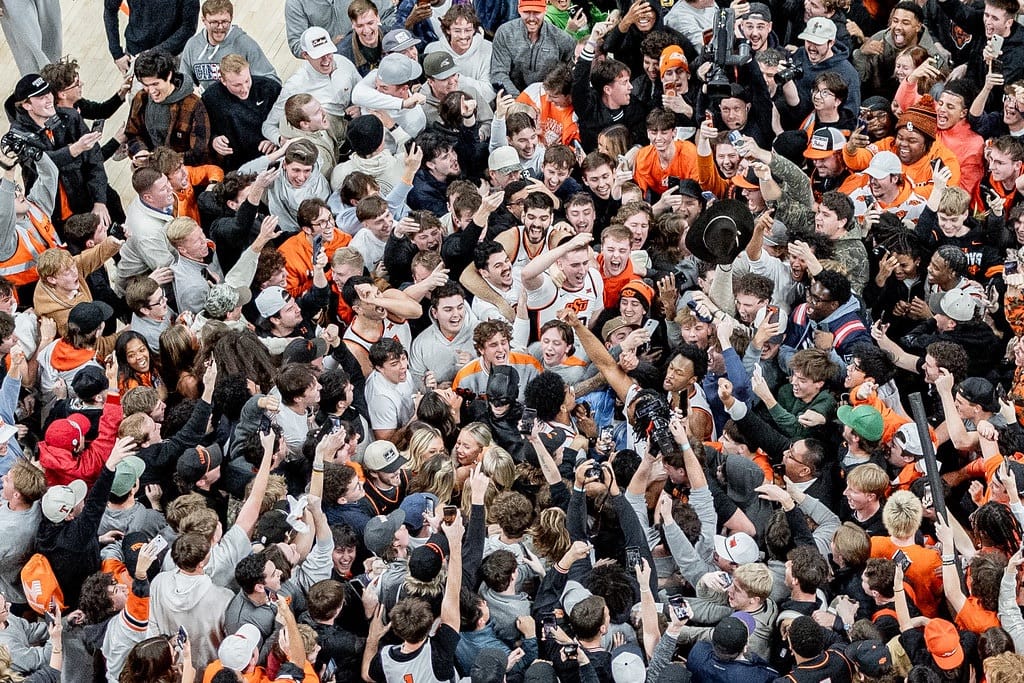 Oklahoma State fans storm the court after 99-92 upset win over BYU on Feb. 4, 2026. The game later resulted in a $50,000 Big 12 fine for fan conduct violations during the contest.