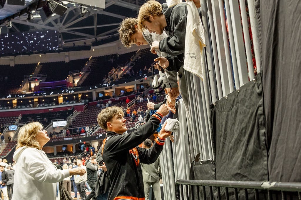 Landon Robideau signs autographs for fans after winning the 157-pound NCAA Championship final against Nebraska's Antrell Taylor at Rocket Arena in Cleveland.