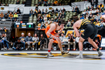 OSU wrestler Jax Forrest in orange singlet assumes wrestling stance facing Missouri opponent in black singlet at Hearnes Center during Cowboys 33-3 dual meet victory Jan. 23, 2026