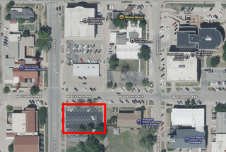 An aerial map showing the parking lot at 7th Ave & Duck St and the nearby Methodist church and Payne County admin building