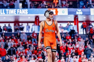 Sergio Vega standing on mat in Oklahoma State singlet after pinning Nebraska's Brock Hardy