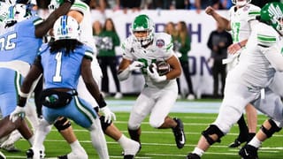 North Texas running back Caleb Hawkins carries football against Tulane defenders during American Athletic Conference Championship Game in New Orleans on Dec. 5, 2025.