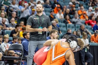 Oklahoma State wrestling head coach David Taylor stands on the sideline during a dual meet in Tulsa on Nov. 16, 2025