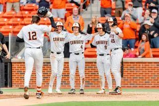 Colin Brueggemann (12) approaches home plate as Brock Thompson (1), Campbell Smithwick (4), Danny Wallace (9), and Deacon Pomeroy (45) wait after his grand slam vs. Missouri State.