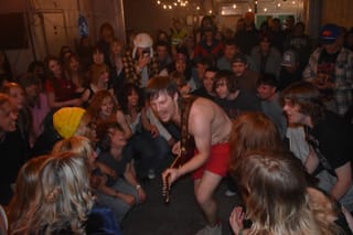 Ugly Cowboys guitarist Sam Miess performs shirtless among a packed crowd at Velvet Fudge in Stillwater during the March 27 Release Radar OSU showcase.