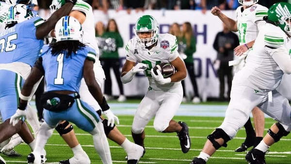 North Texas running back Caleb Hawkins carries football against Tulane defenders during American Athletic Conference Championship Game in New Orleans on Dec. 5, 2025.