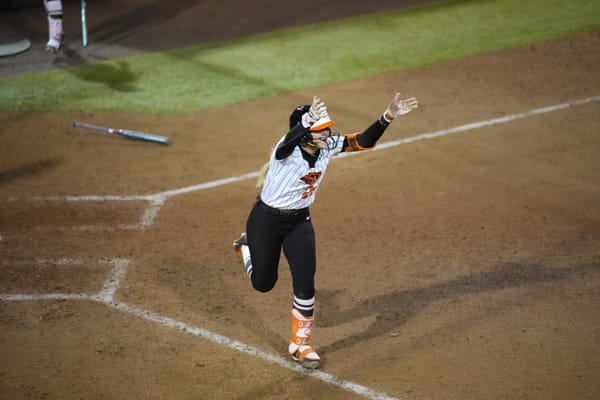 OSU third baseman Rosie Davis (26) celebrates at home plate after her walk-off homer ends an 11-inning thriller against No. 6 Nebraska on Feb. 26, 2026.