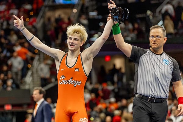 Jax Forrest has his hand raised by the referee after winning the 133-pound title at the 2026 NCAA Wrestling Championships in Cleveland.