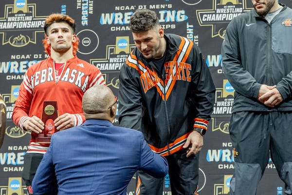Konner Doucet of Oklahoma State stands on the podium at the 2026 NCAA Wrestling Championships, finishing fourth at heavyweight in Cleveland.